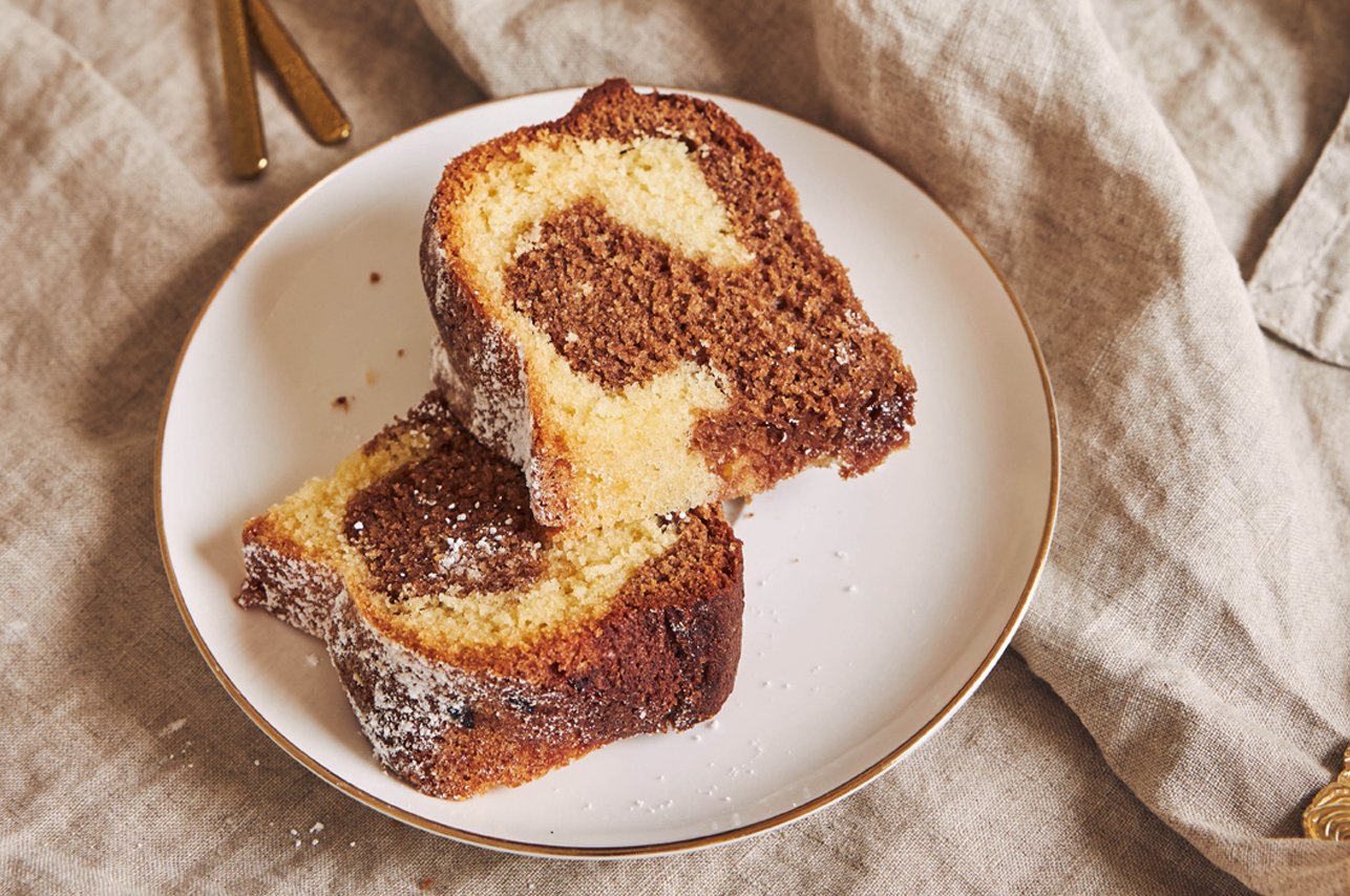Bunch of fresh carrots with green leaves over wooden background