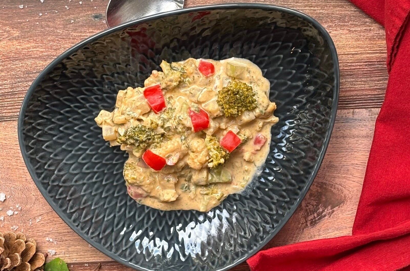 IMG_8760-1-scaled Ein dunkler Teller mit knackigem Gemüse in einer hellen Sahne Soße.